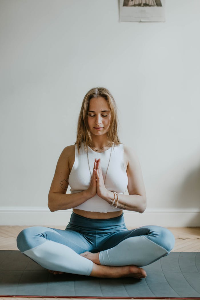 about-01 A serene image of a woman practicing meditation indoors, promoting mindfulness and wellbeing.