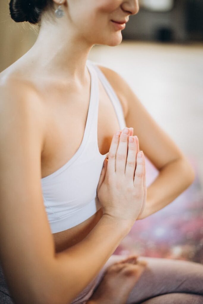 pexels photo 3822623 A woman meditating indoors, focusing on mindfulness and relaxation.
