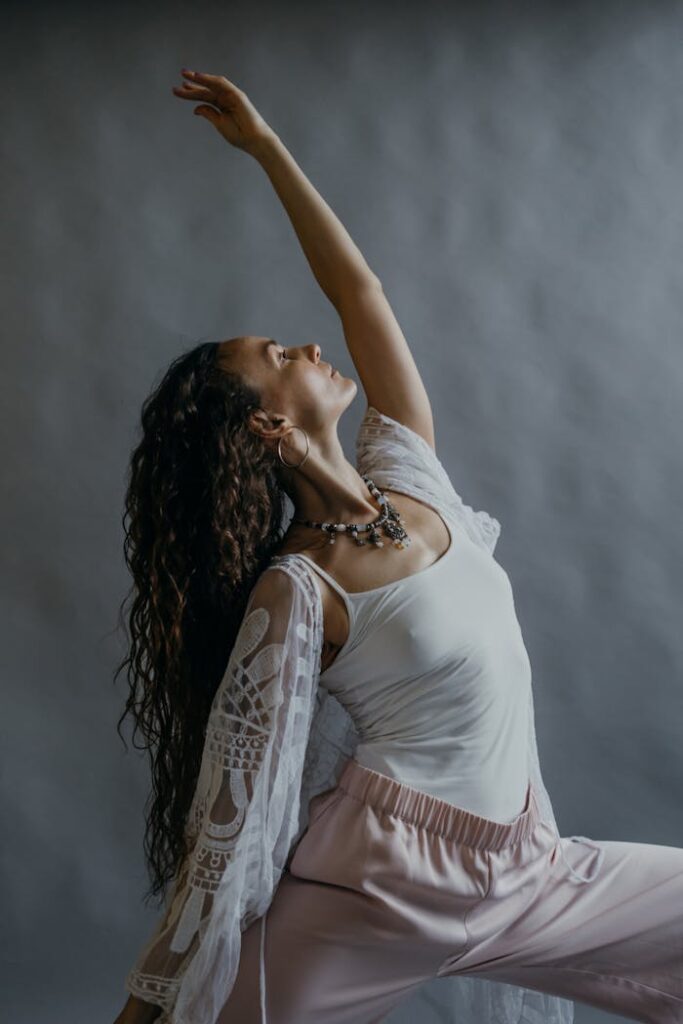 pexels photo 6019787 Woman in a graceful yoga pose, demonstrating flexibility and mindfulness in a studio setting.